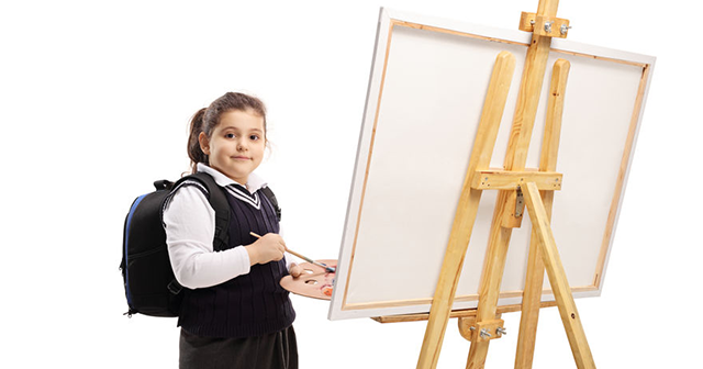 child at an easel, art