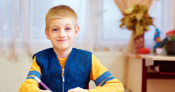 March is Developmental Disabilities Awareness Month boy at desk
