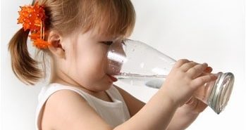girl drinking water from a glass