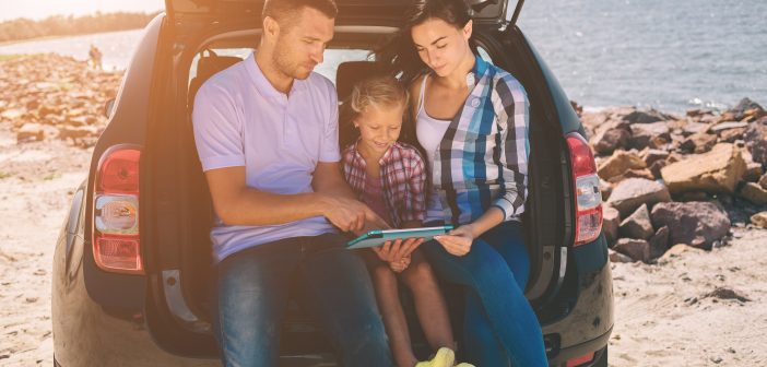 parents and child on a road trip