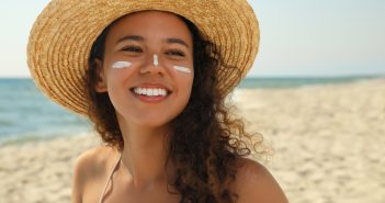 woman on beach wearing sunscreen
