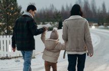 family walking in snow