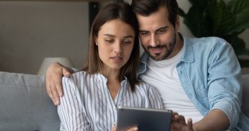 young couple looking at an ipad, finances