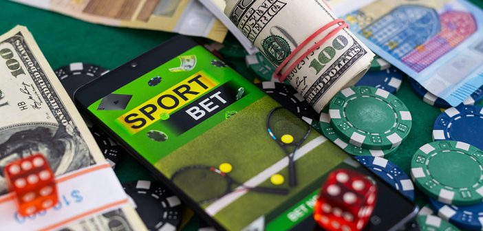 gambling problem, Money, mobile phone and rugby ball on dark wooden background. Concept of sports bet.