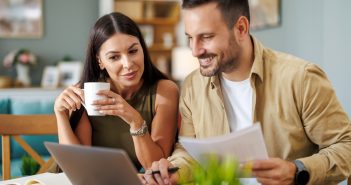 young couple with financial or other planning documents