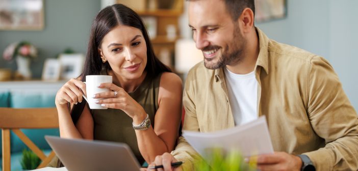 young couple with financial or other planning documents