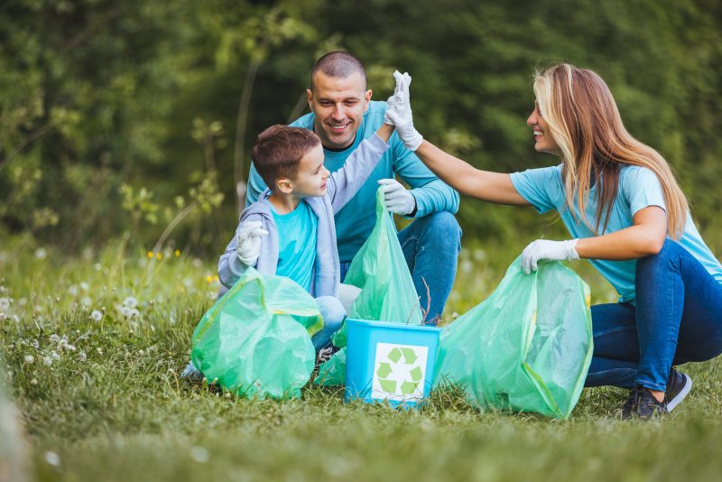 family volunteering, picking up trash, recycling