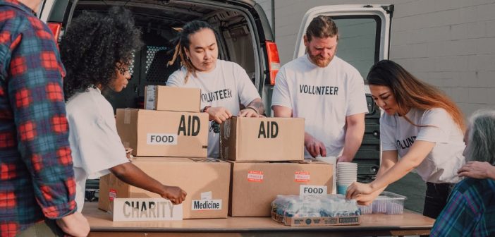 volunteers handing food aid