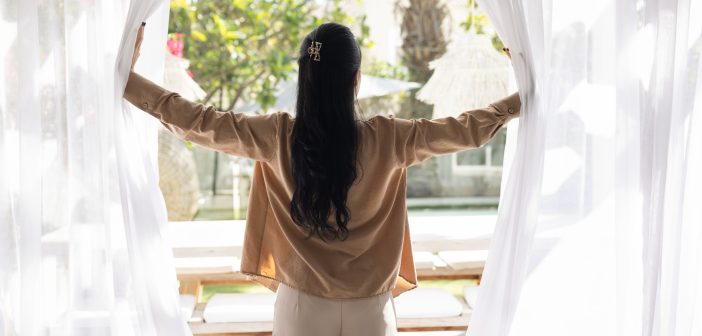 woman at open window, let fresh air in