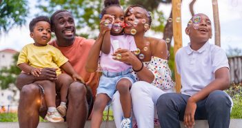 African,Black,Ethnic,Family,With,Children,In,Playground,Blowing,Soap